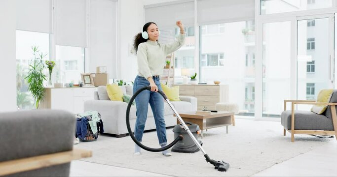 Cleaning, music and woman dance with vacuum, headphones and fun in her home on the weekend. Housekeeping, earphones and female dancing to radio, podcast and spring clean her house with dust machine