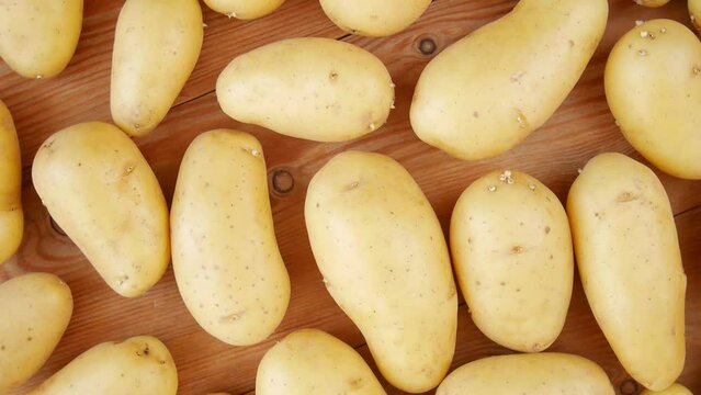 Raw potatoes on the table.