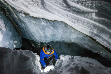 High angle view of climber in glacial crevasse