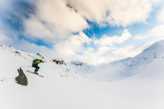 Backcountry skier finds a jump off a small rock