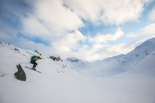 Backcountry skier finds a jump off a small rock