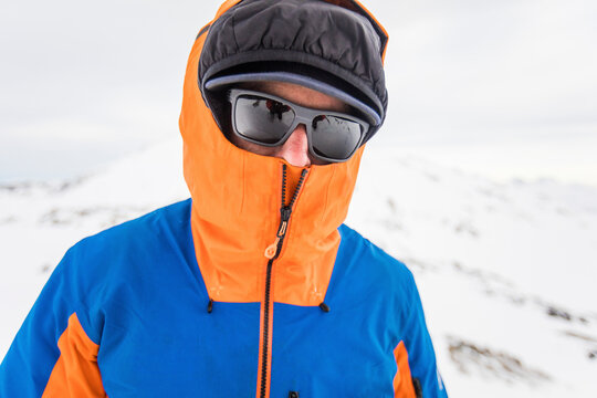 View of mountaineer staying warm with face and head covered