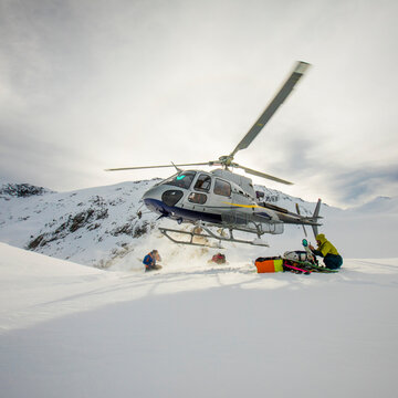 Square crop of helicopter lifting off in winter conditions