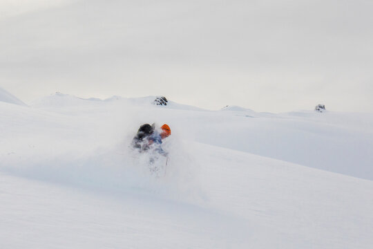 Skier covered in powder while backcountry skiing in B.C. Canada