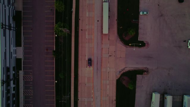 Top down aerial at sunset while dry van-reefer semi truck driver is driving. Ilinois, America, Downers Grove in the evening