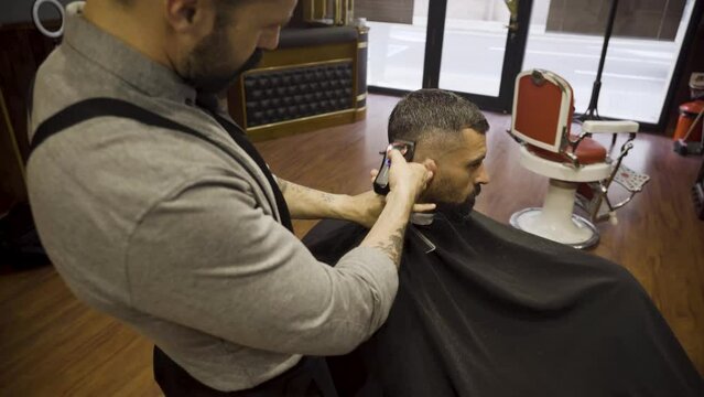 Close-Up View Of A Male Haircut With Electric Razor In A Barber Shop.