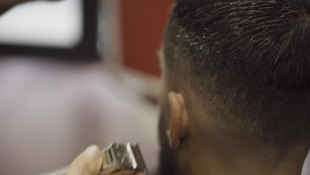 Barber Cut The Client's Hair Using A Razor. Close Up