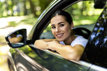 Young woman driving her car outdoors