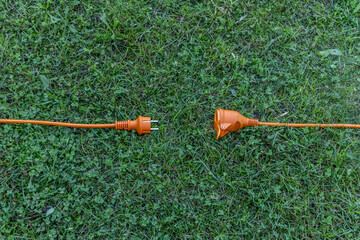 Fototapeta Electric extension cord and power connection in the garden obraz