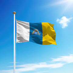 Waving flag of Canary Islands is a community of Spain on flagpole