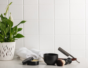 Shaving accessories on a white table in the bathroom.Men's self-care concept.