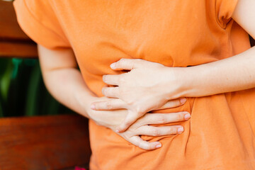 Women have abdominal pain due to menstruation or gastritis. Concept of health problems.