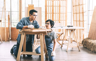 Southeast asian family father and son diy or repair for crafts skill at home workshop