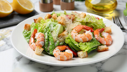 Delicious Caesar salad with shrimps on white marble table, closeup