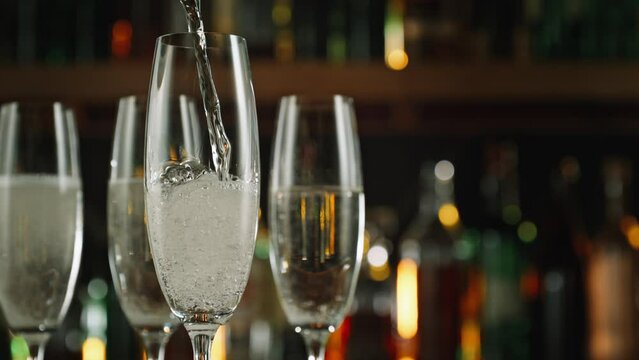 Super Slow Motion Shot of Pouring Champagne Wine into Glass Before Bar at 1000fps.