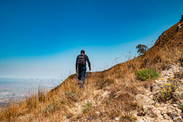 Fototapeta premium A hiker against the background of Mbeya Paek in Mbeya Mountain Range in Tanzania