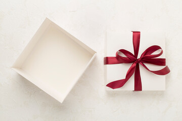 Open gift box on concrete background, top view. Mock up for design