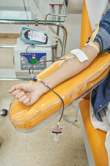Unrecognizable female patient donating blood in clinic