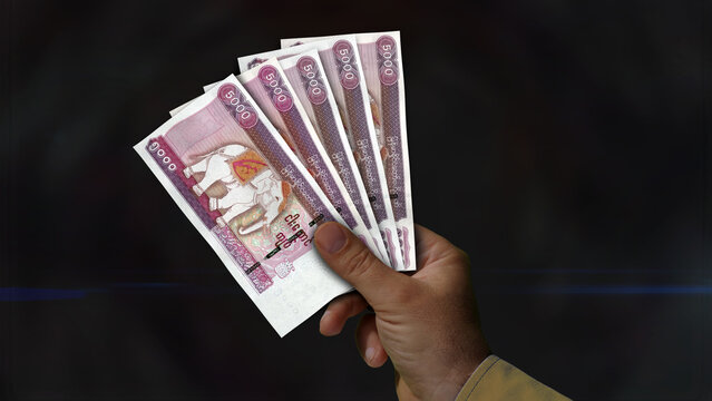 Myanmar Kyat growing pile of money in hand concept 3d illustration