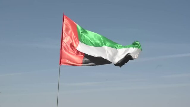 Low angle video of the UAE flag against the sky