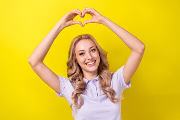 Fototapeta na wymiar Photo of cheerful cute lady wear purple polo showing two arms heart isolated yellow color background