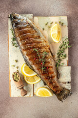 grilled trout with lemon pieces, vertical image. top view. place for text