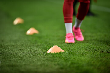 Soccer players training with dribbling cones on turf - 635401935