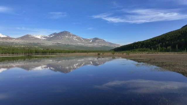 Beautiful mountain landscape with reflection on the lake in Rondane National Park, Norway