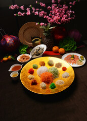 fresh colourful asian festive vegetables salad lo hei yu sheng with smoked salmon, fish skin, cookies and sweet spicy sauce buffet corner for chinese new year halal food menu for banquet restaurant