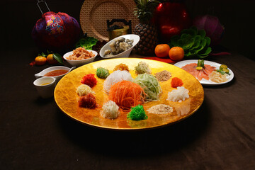 fresh colourful asian festive vegetables salad lo hei yu sheng with smoked salmon, fish skin,...
