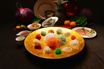 fresh colourful asian festive vegetables salad lo hei yu sheng with smoked salmon, fish skin,...