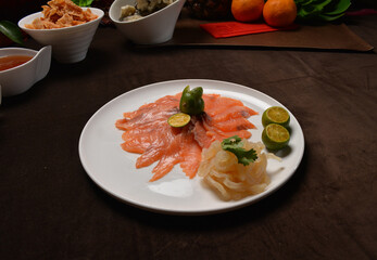 fresh colourful asian festive vegetables salad lo hei yu sheng with smoked salmon, fish skin, cookies and sweet spicy sauce buffet corner for chinese new year halal food menu for banquet restaurant