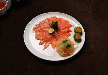 fresh colourful asian festive vegetables salad lo hei yu sheng with smoked salmon, fish skin, cookies and sweet spicy sauce buffet corner for chinese new year halal food menu for banquet restaurant