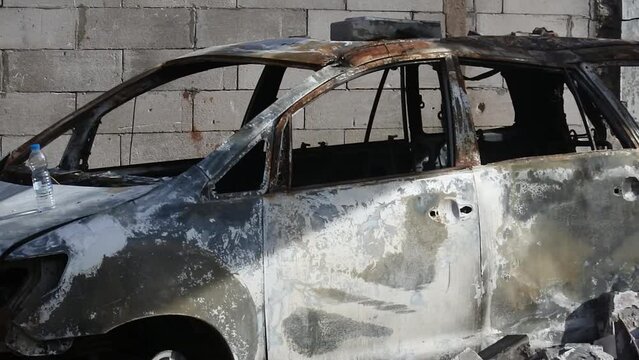 Pan Shot of a car caught on fire as a result of an exploding fuel oil storage tank near a densely populated residential area in Plumpang, North Jakarta, Indonesia