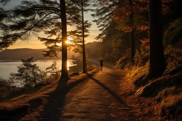Morning Run Runner jogging along a scenic sunrise-lit - stock photo concepts
