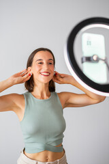 influencer girl. happy girl recording a video for social networks. It is showing her ears with earrings