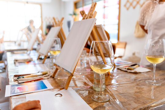 Art and Wine Workshop. White wine glasses with canvases to paint.
