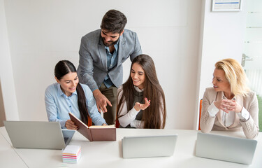 Fototapeta premium Collaborative colleagues working together on a common office project.