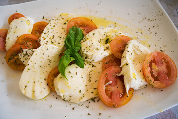 Plate of caprese salad, tomato, mozzarella and basil
Typical food of Puglia, in the south of Italy