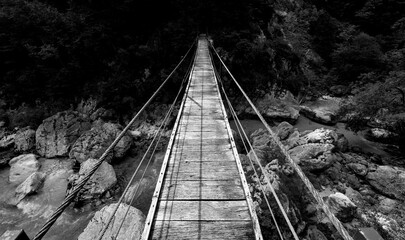 Panoramic view of wooden suspension brige spanning over Soca river (Slovenia) – part of a hiking...