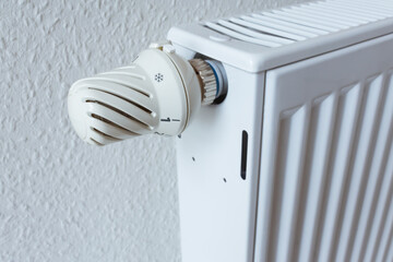 Detail of turned off thermostat, temperature knob of heating radiator. Saving energy and warm home concept, living costs.