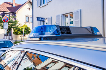 German police car on the street, detail of blue siren flasher.