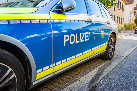 German police car on a street. Side view of a police car with the lettering Polizei. Police patrol car parked.