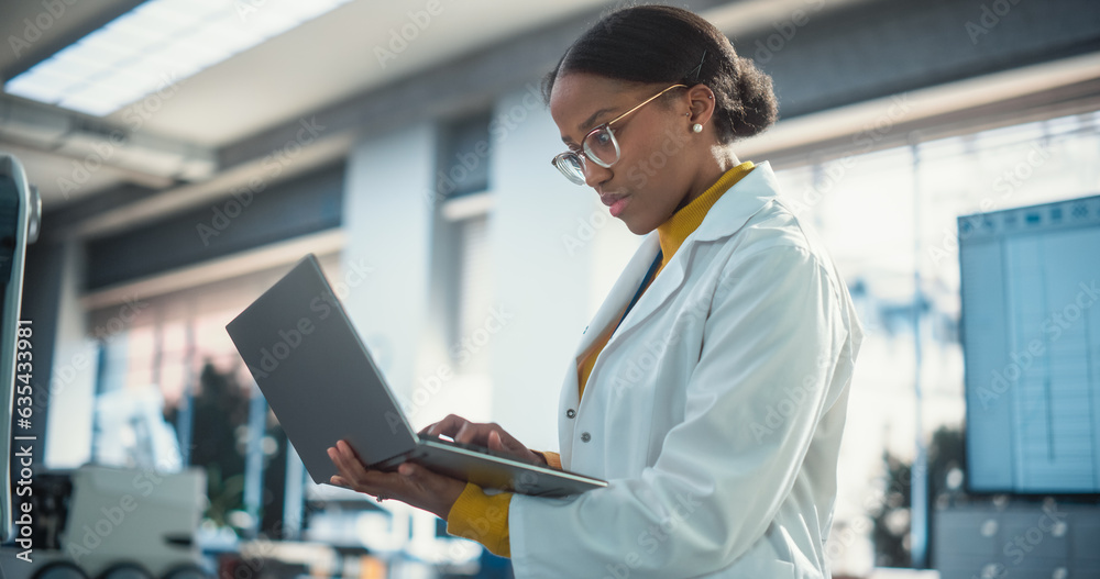 Aufkleber portrait of young black female specialist in lab coat using laptop computer to test an ai robotic pr