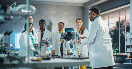 Diverse Team of Males and Females Discussing Ideas in Technological Startup Lab. Group of International Students Listening to Robotics Professor While He Explains AI Robot Prototype Components.