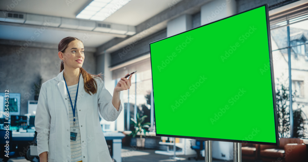 Poster excited young female specialist doing a presentation, using green screen monitor and talking to her 