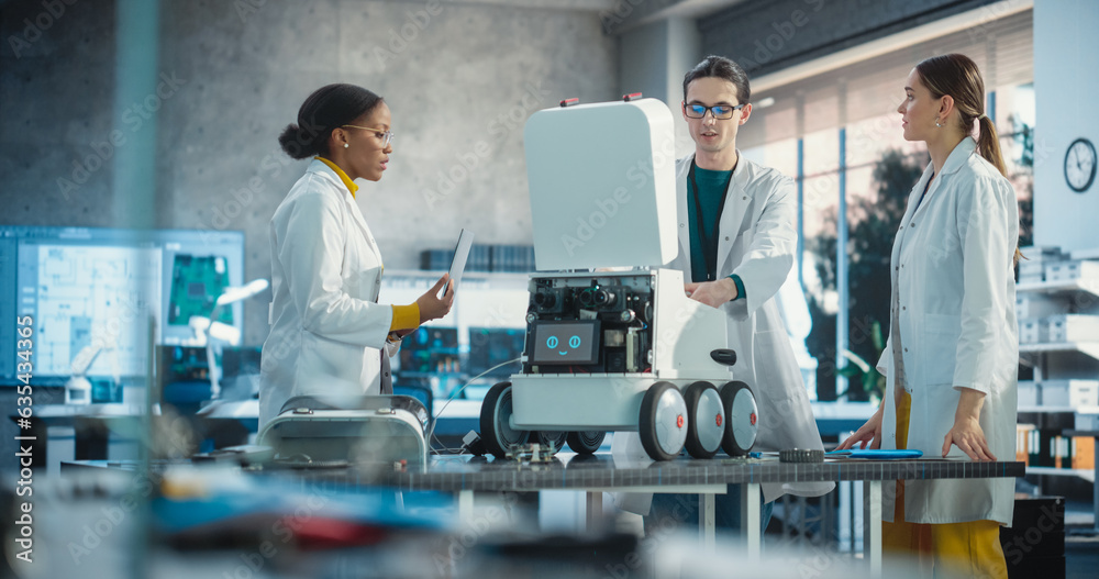 Poster Team of Industrial Specialists Working on Mobile Robot, Using a Laptop. Young Male and Female Engineers in a Lab Discussing an Automated AI Robotic Delivery Assistant, Brainstorming New Ideas