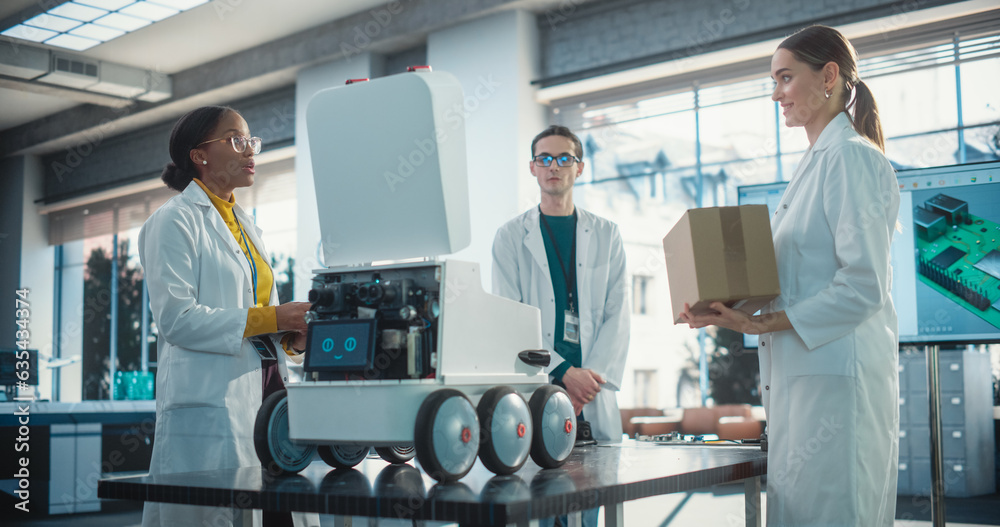 Poster Diverse Team of Industrial Specialists Working on Remotely Controlled Robot, Using a Laptop. Young Male and Female Engineers Discussing Autonomous AI Delivery Assistant Prototype, Brainstorming