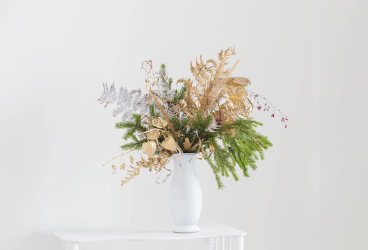 christmas bouquet in white vase on white background