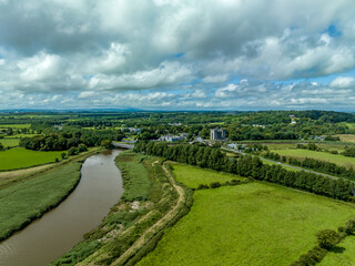 Aerial view of Bunratty Castle  large 15th-century tower house in County Clare in Ireland guarding the crossing on the Ralty river before it reaches the Shannon estuary